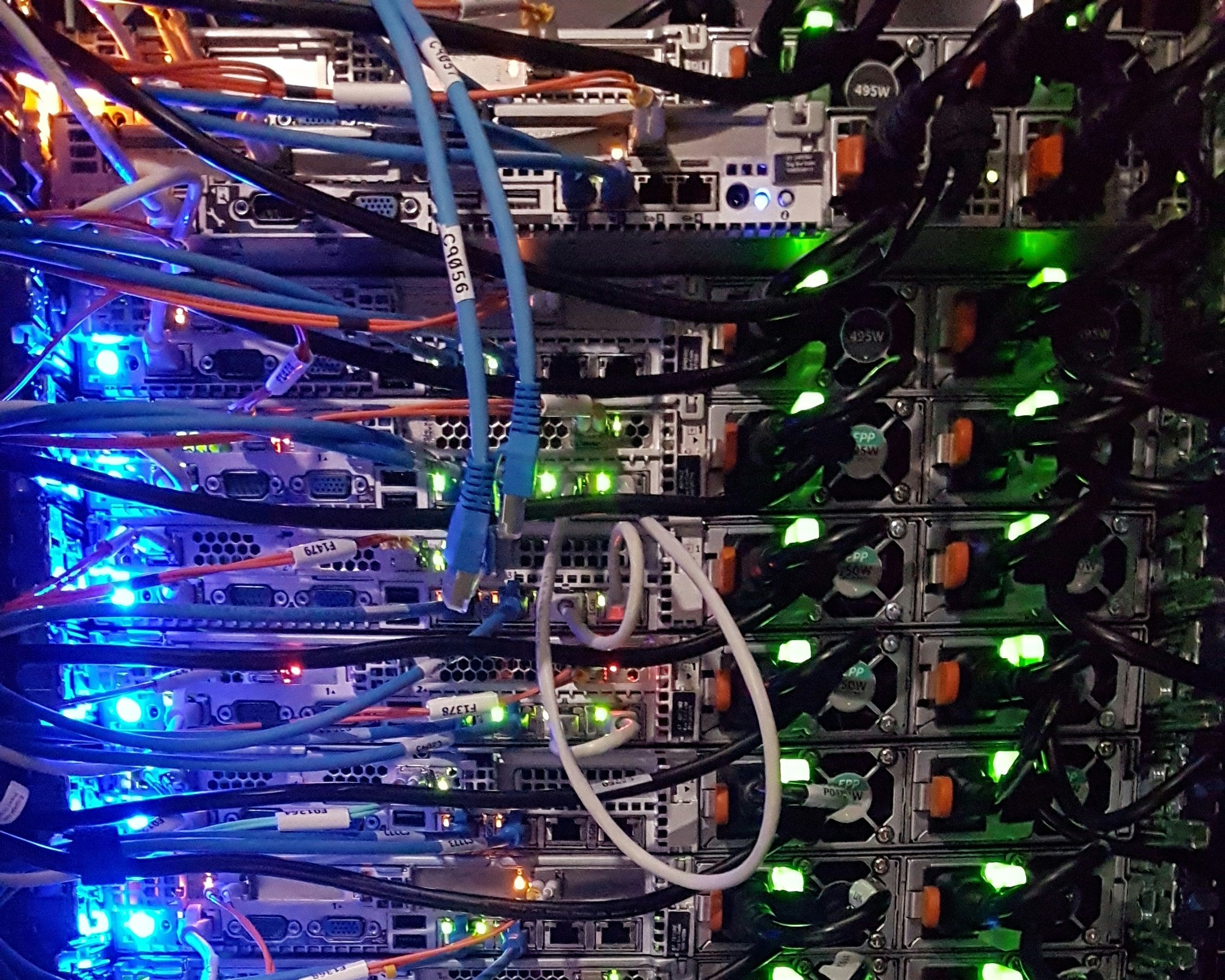 Server rack with numerous cables and network equipment in a data center setting